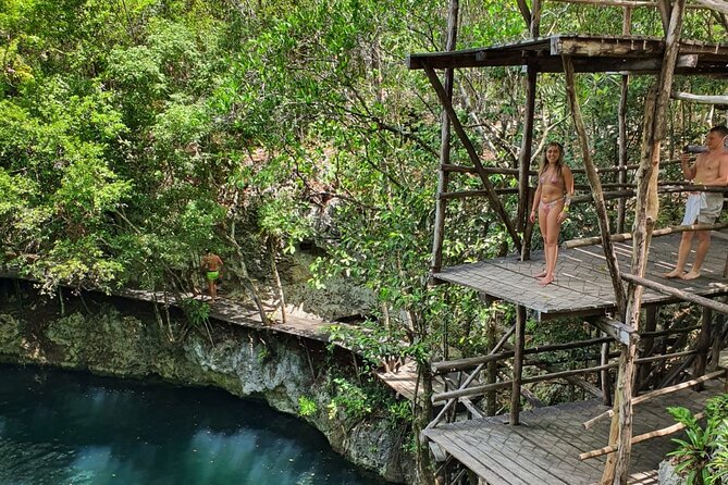 ATV Tour Zipline and Explore 2 Hidden Cenotes - Stop 1 at Cenote Kin-Ha, where sun rays paint the water