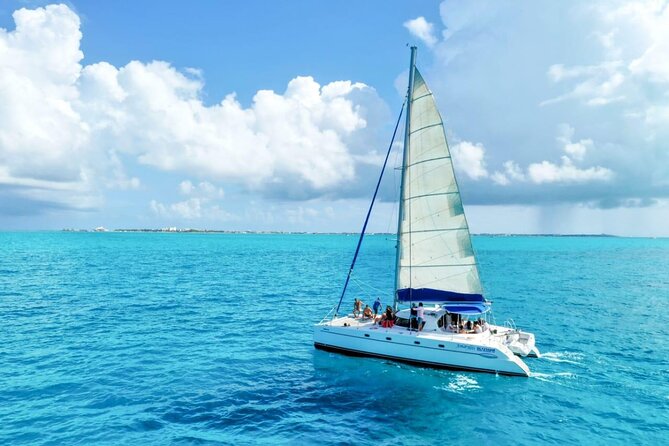Isla Mujeres: Catamaran Tour with Snorkeling Food, Drinks, Beach - Spinnaker flight, wind changes, and how to protect your day