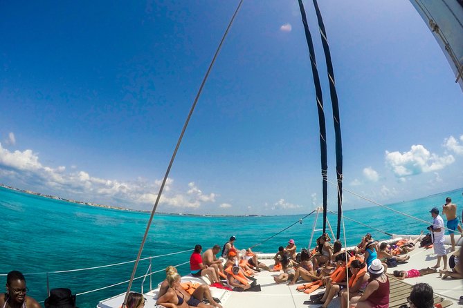 Mujeres Island Tour by Catamaran from Cancun City - The catamaran vibe: open bar energy and boat-day crowding