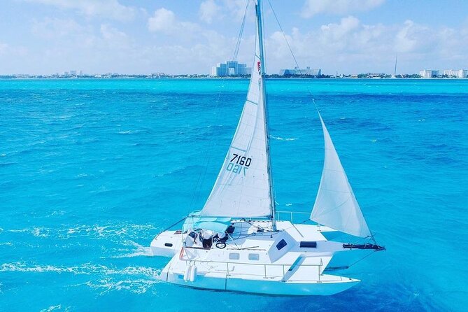 Trip to Isla Mujeres by Catamaran, with snorkeling and drinks - Getting to the marina: pickup options and what to expect